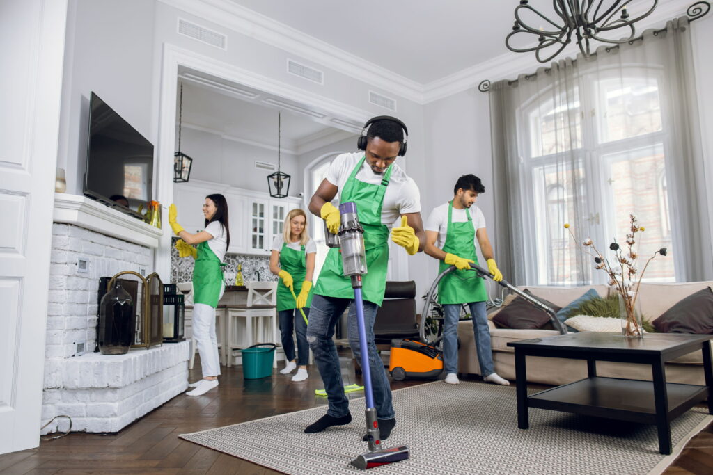 A group of cleaners in a home using various cleaning methods